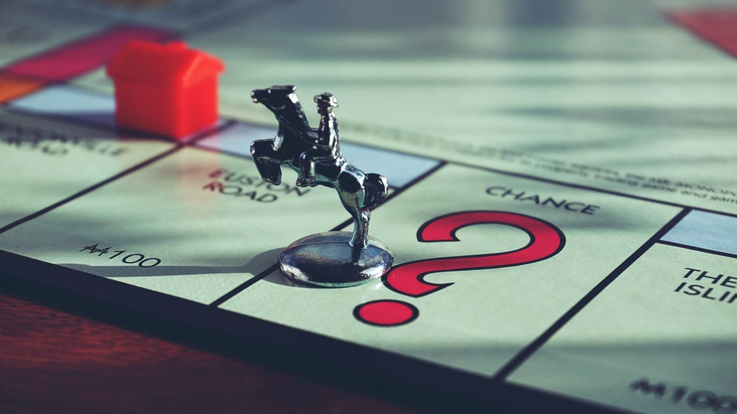 Board game Monopoly with a playing piece on the Chance spot