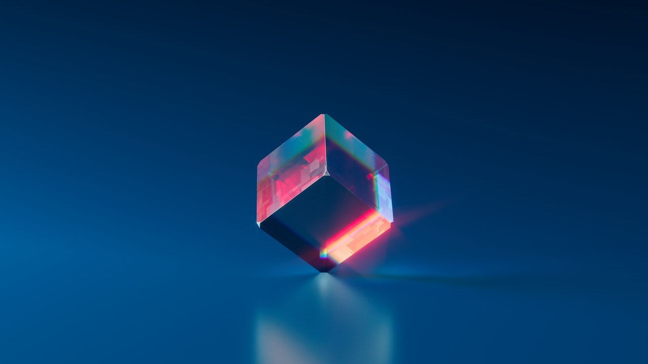 plain clear square cube projecting different colors inside