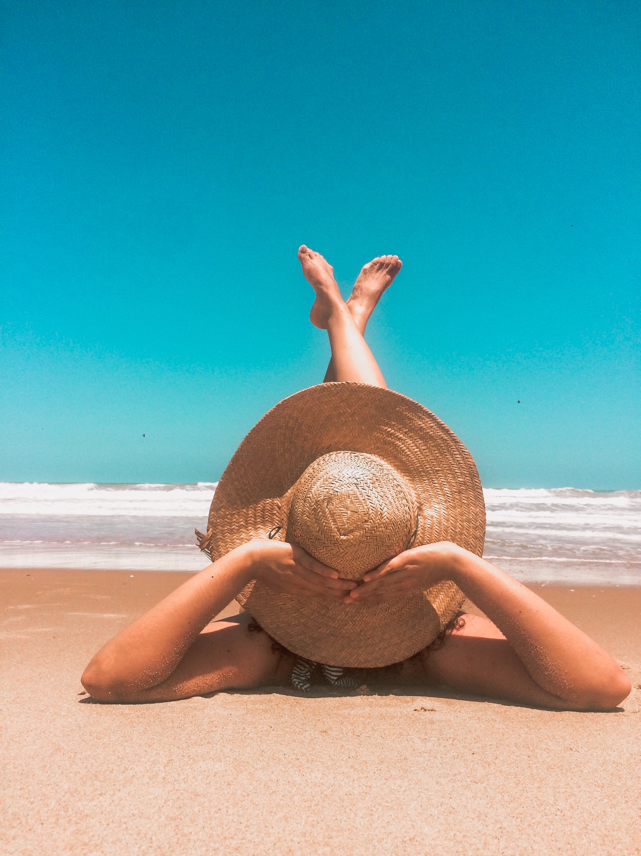 young retired woman on a beach relaxing