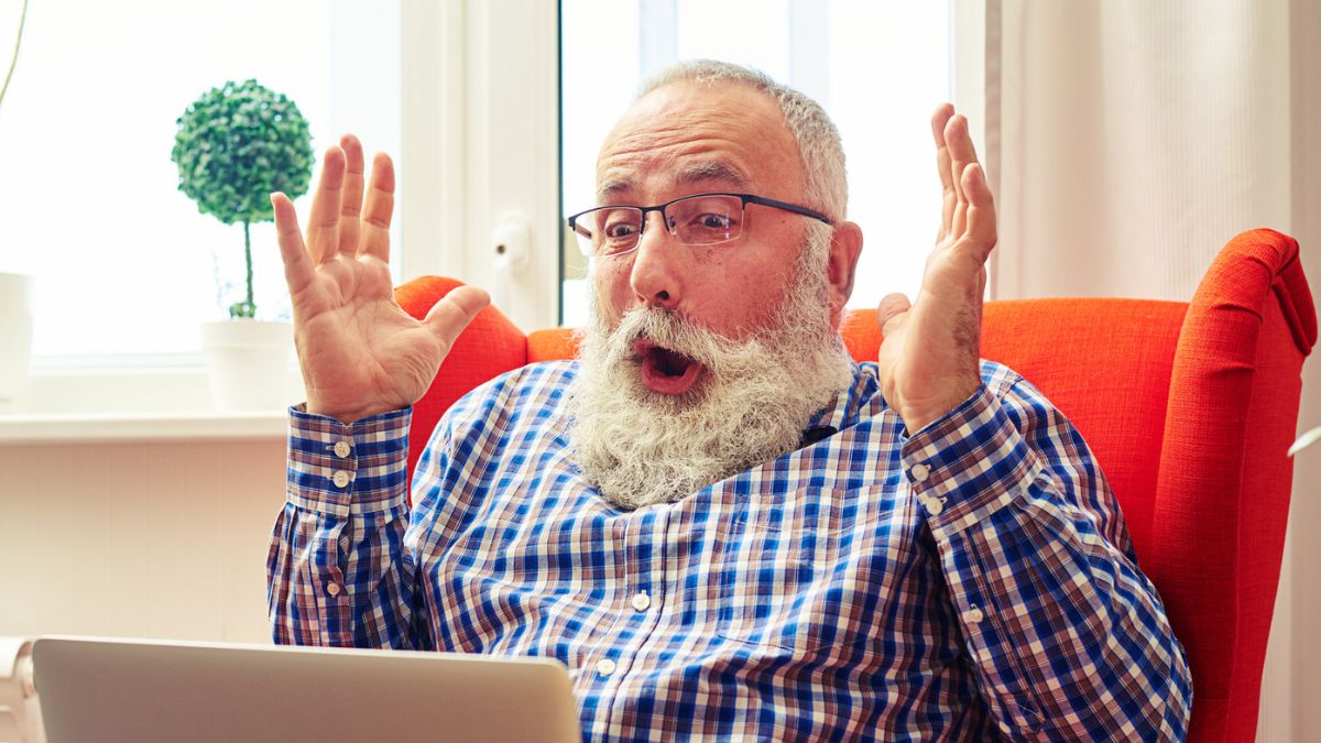 man with beard on laptop