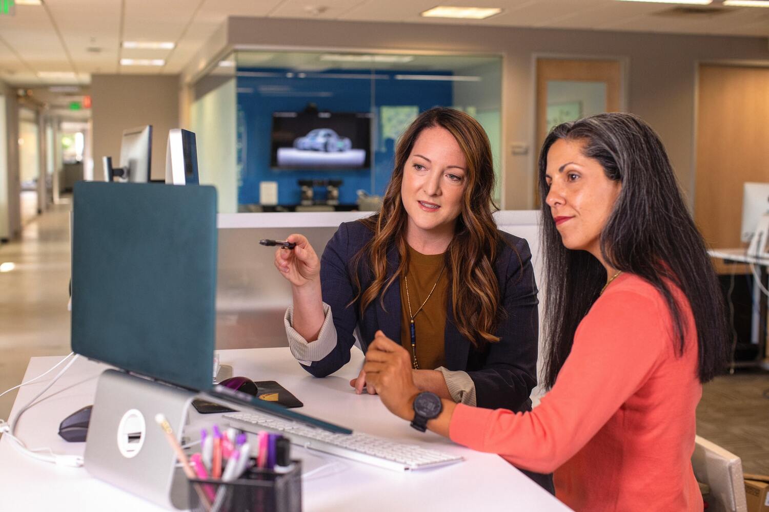 women at work around a computer