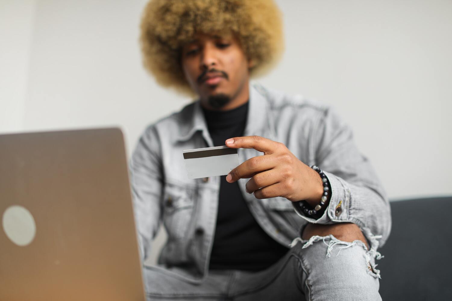 A man using his best prepaid card to purchase things online.