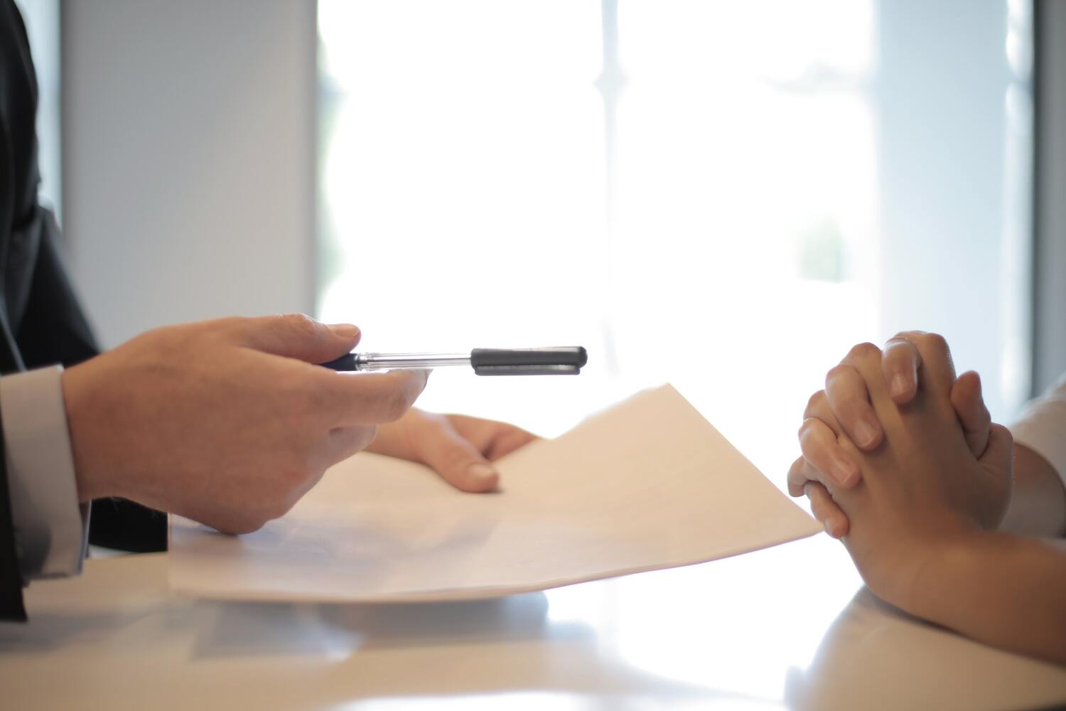 Signing a document to lower student loan interest rates with a lender.