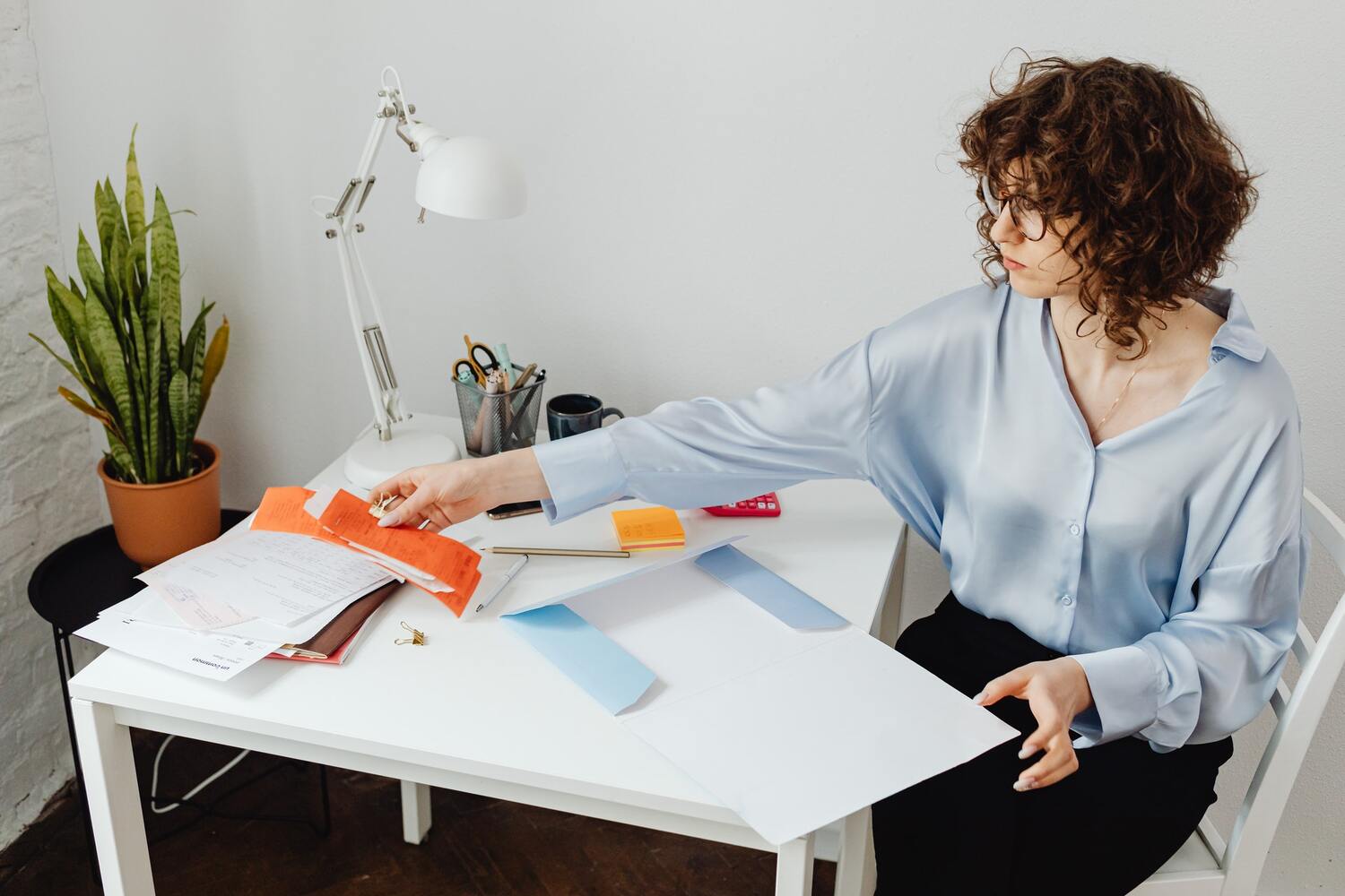 lady organizing her bills on a table.