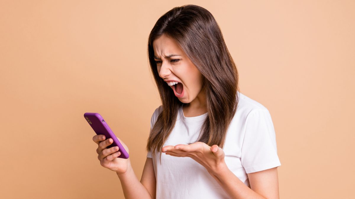 woman mad looking at her phone