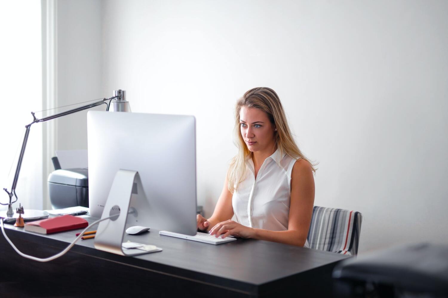 A women at her computer working on email marketing.