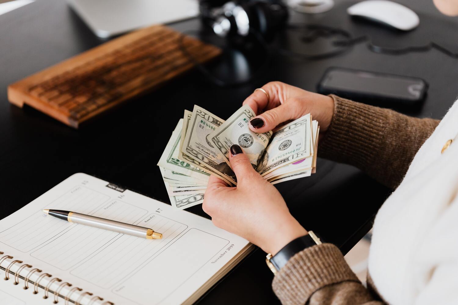 Counting out money to by hand.