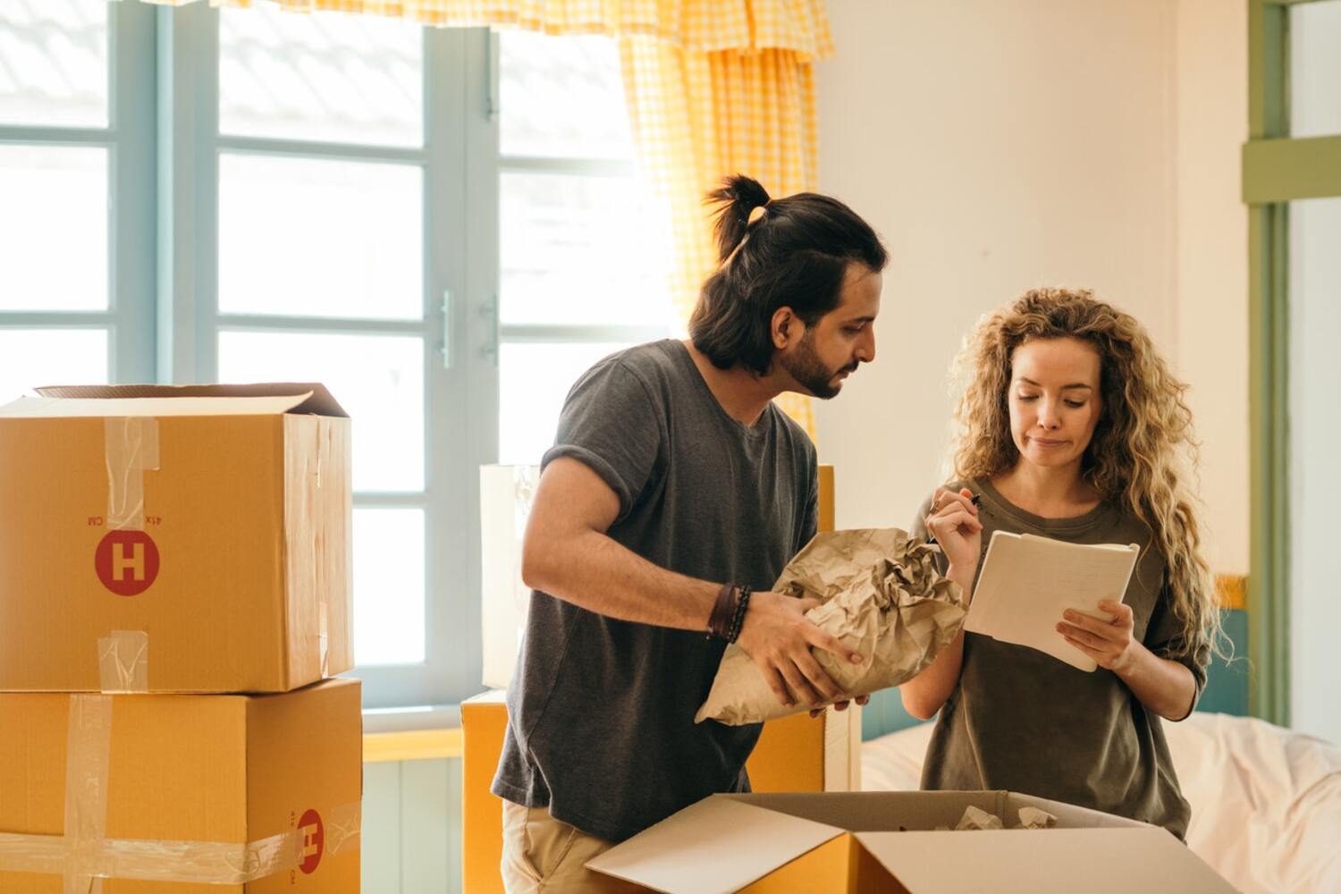 A couple looking at a rent affordability calculator figures.