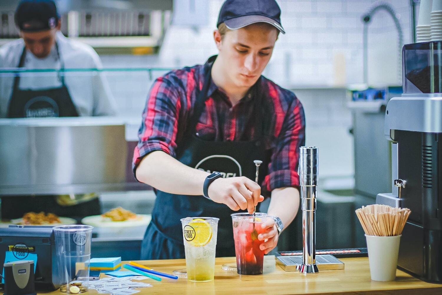 A man making a drink at a seasonal job.