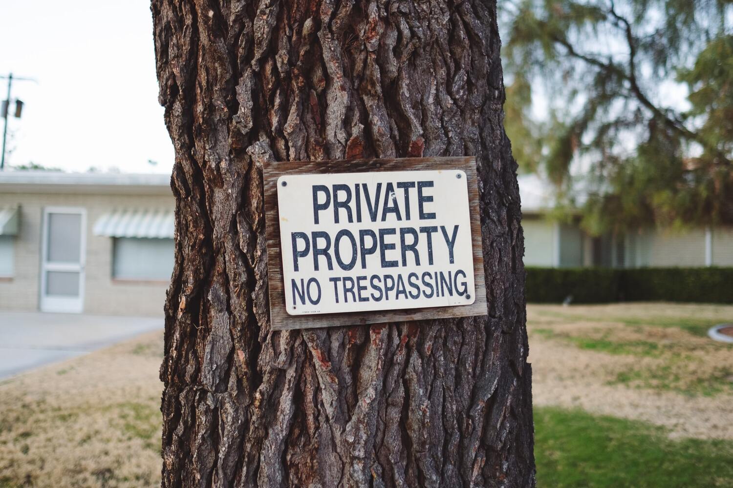 A sign on a tree saying private property.