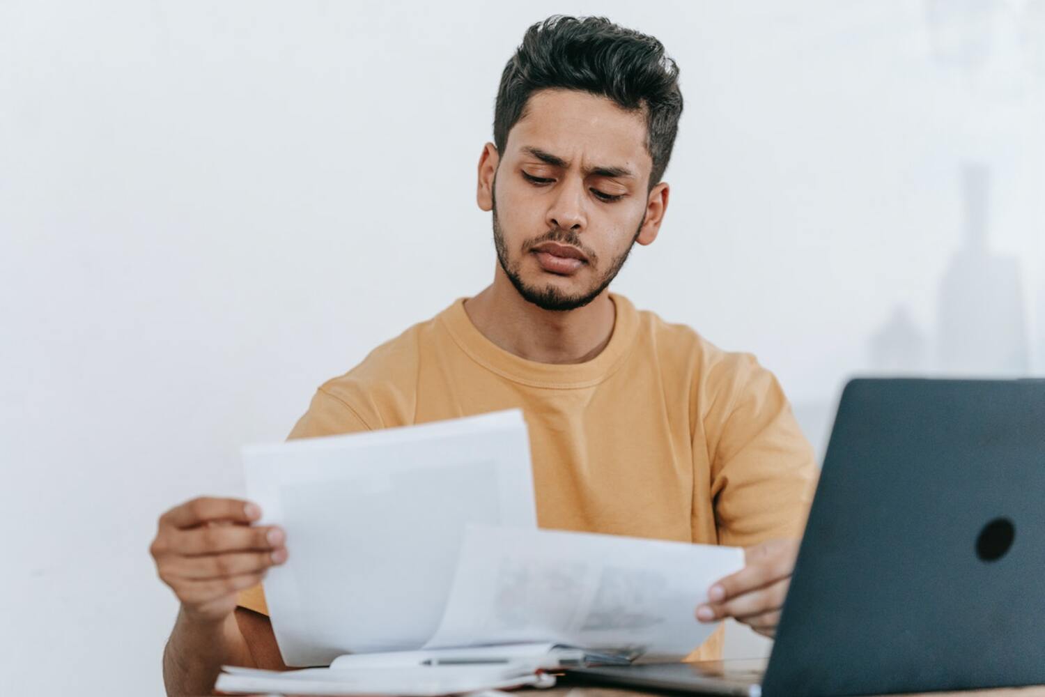 A man reading a Webull Review.