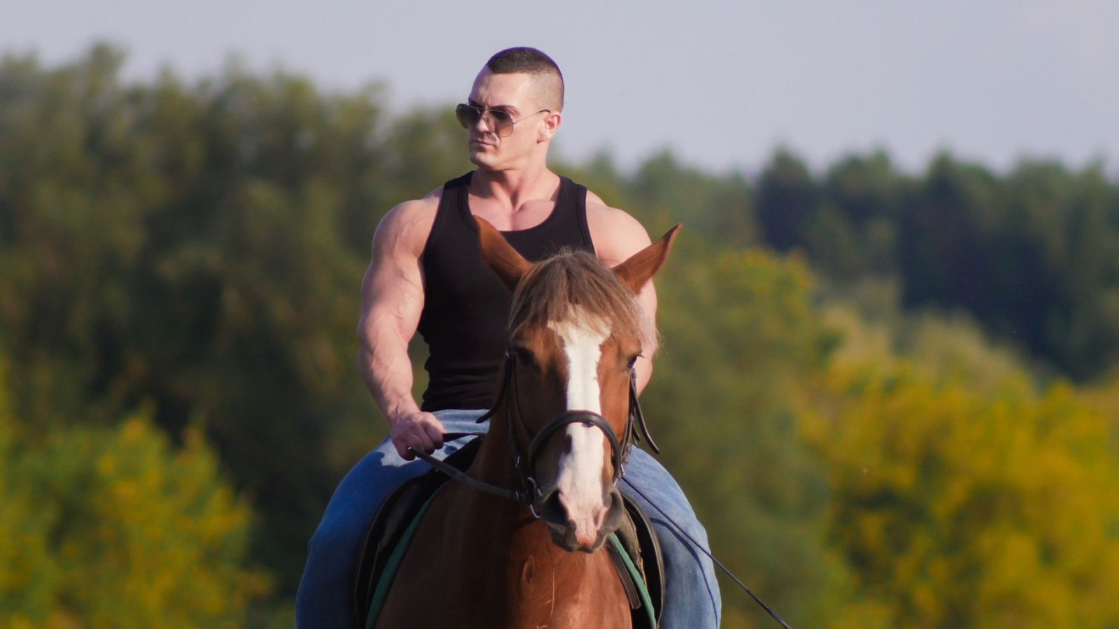 muscle man riding a horse
