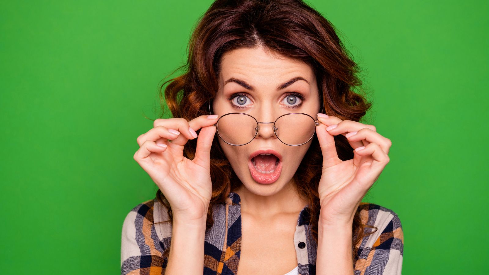 brunette woman with glasses with shocked look