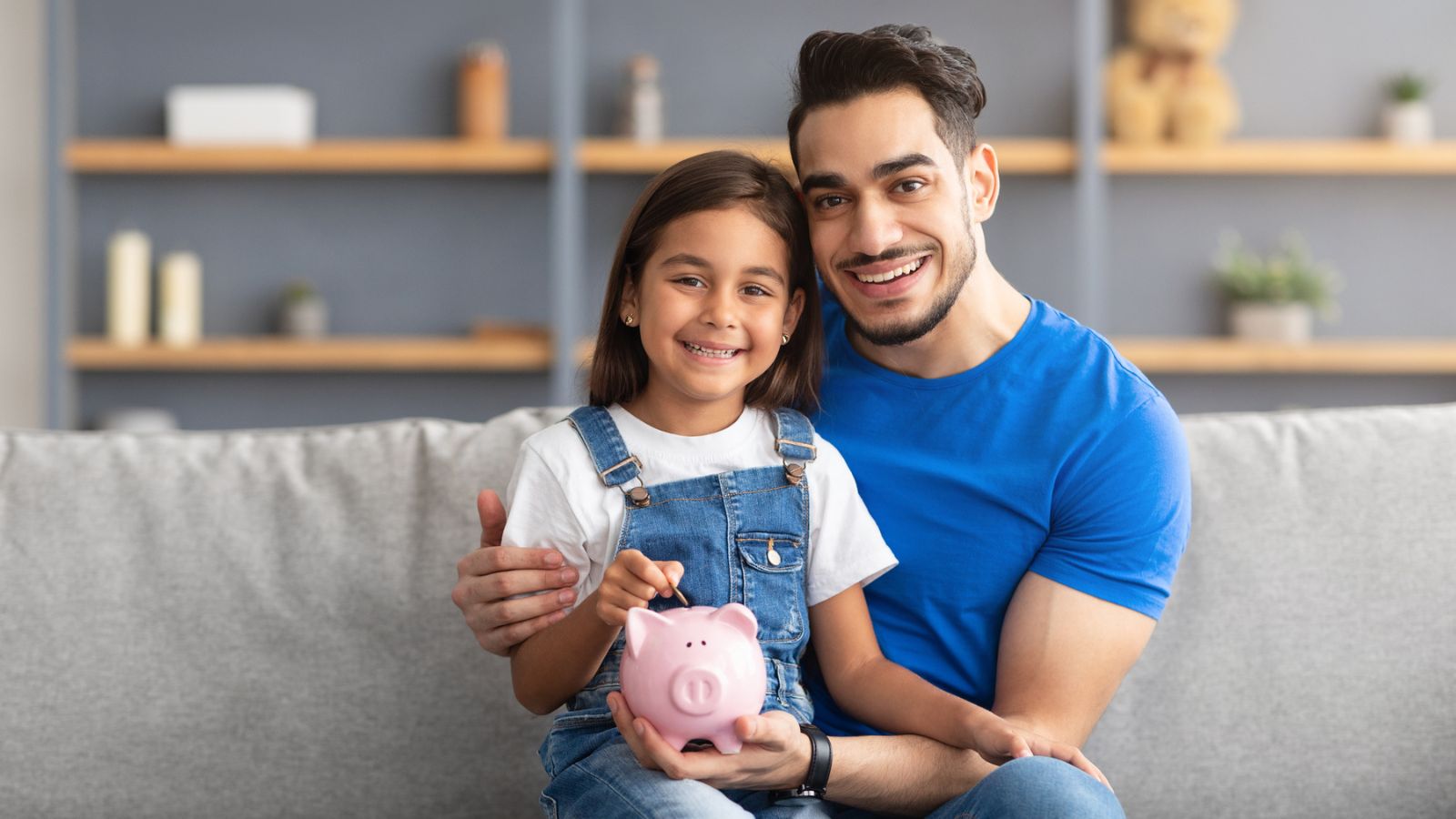 dad with little girl and piggy bank money saving responsibility