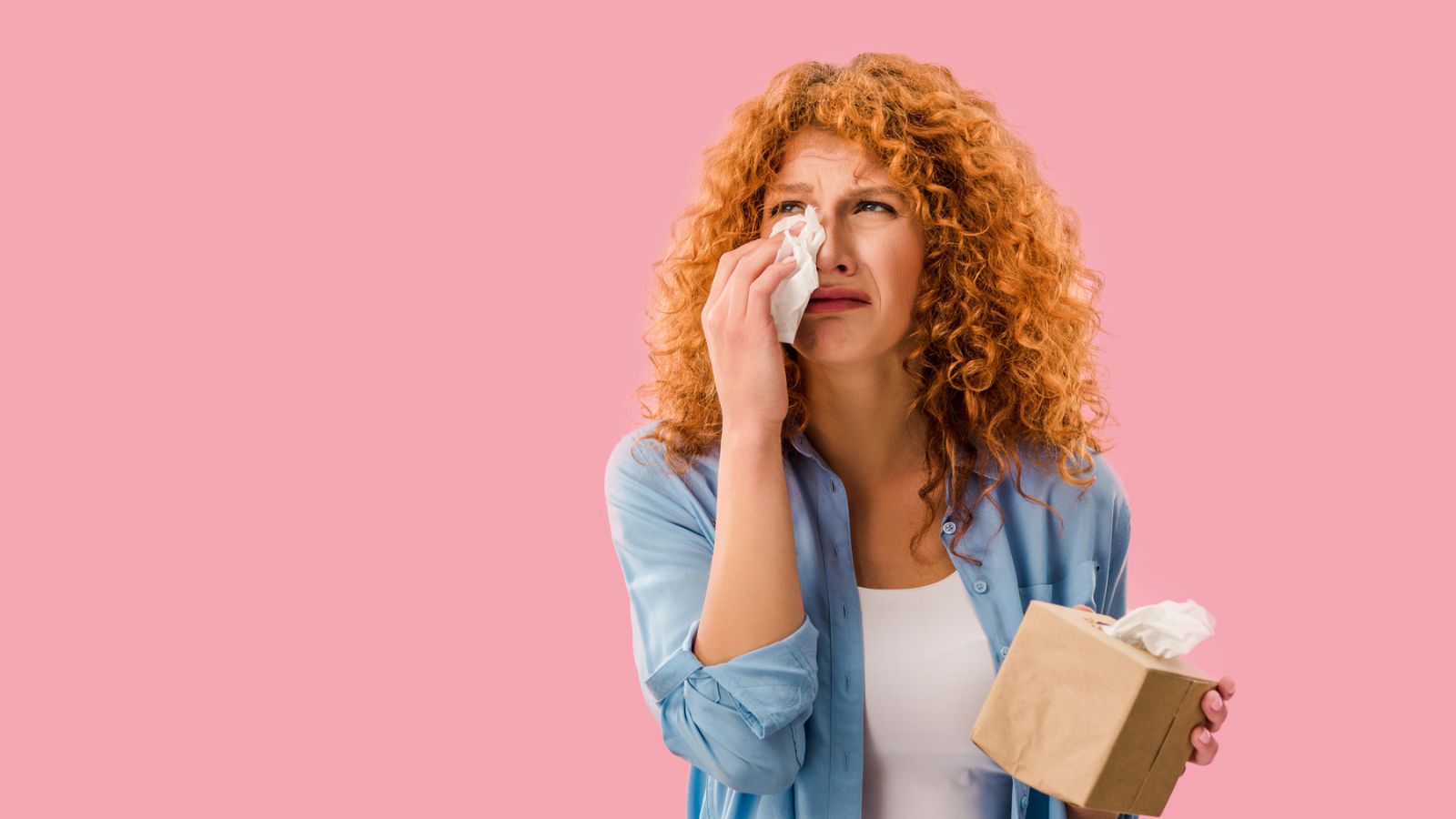 woman crying with tissue box