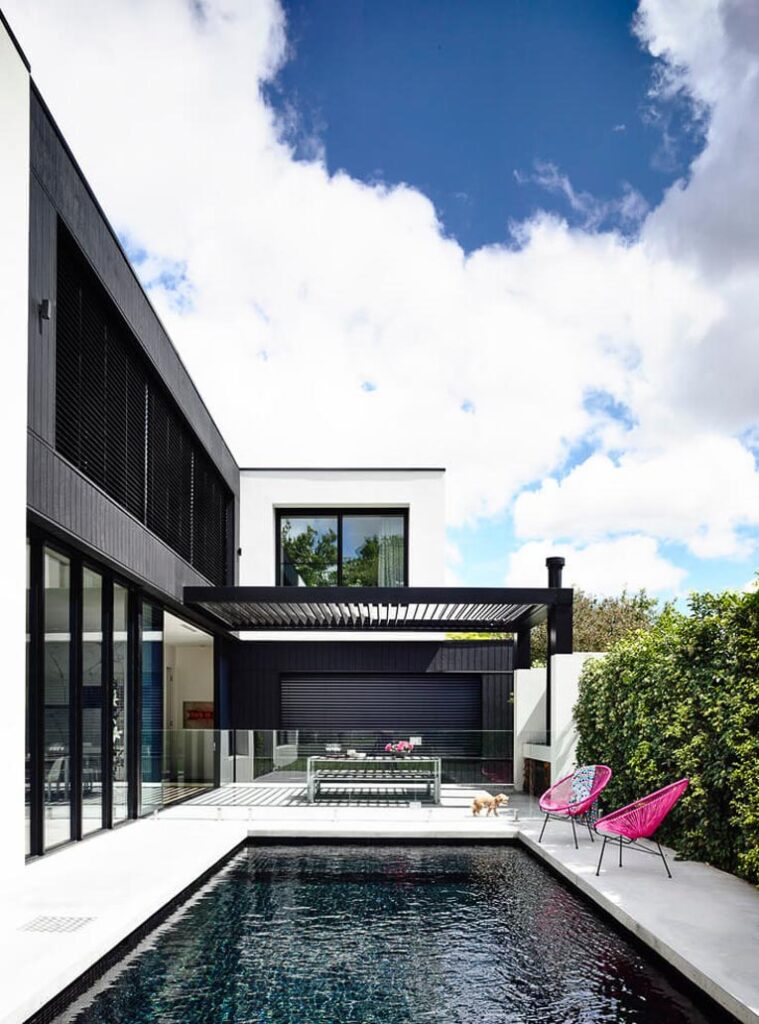 Modern house with a black tile pool.