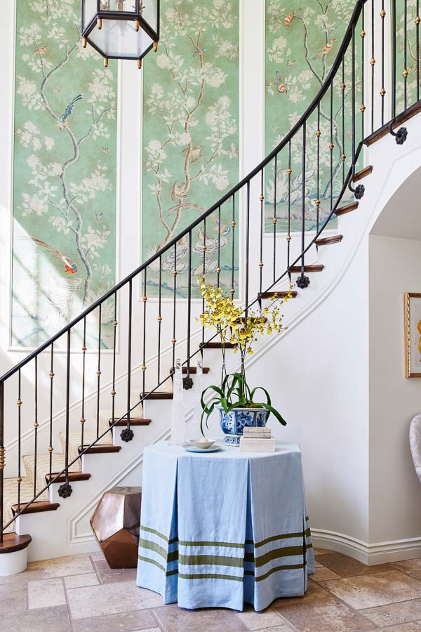 Two story stair well with wallpaper panels.