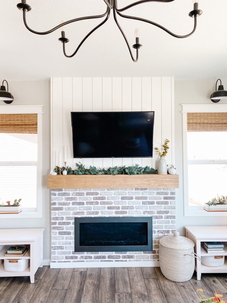 Mixed shiplap and brick fireplace.