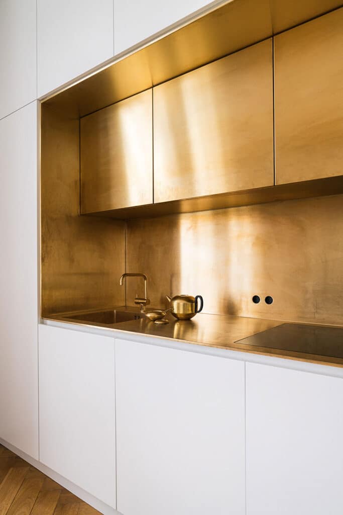 Metal cabinets and backsplash in modern kitchen.