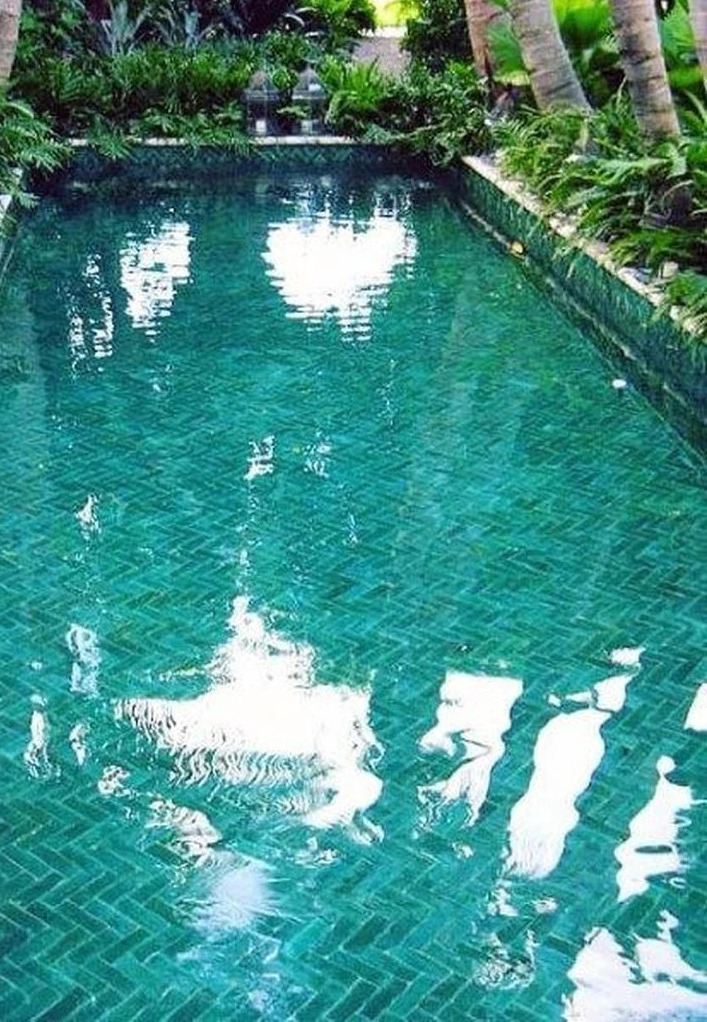 Blue pool with herringbone tile.
