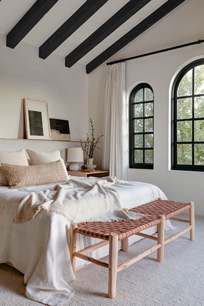 Modern Spanish style bedroom with arched windows.