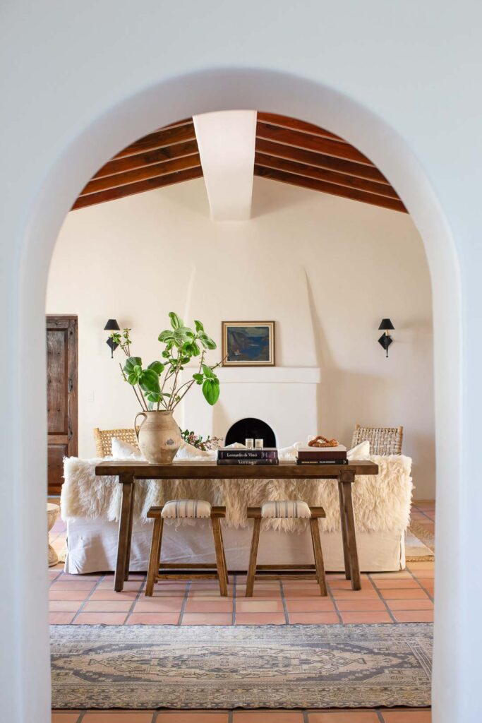 Arched entryway revealing Spanish style living room.