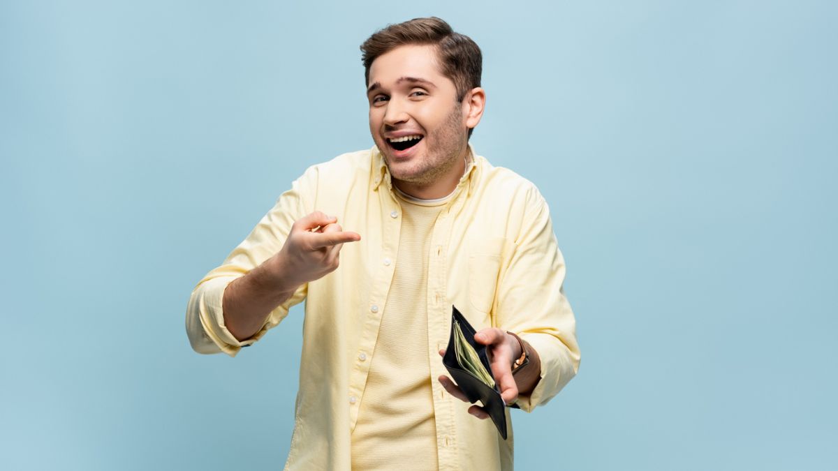 man pointing to his wallet with money