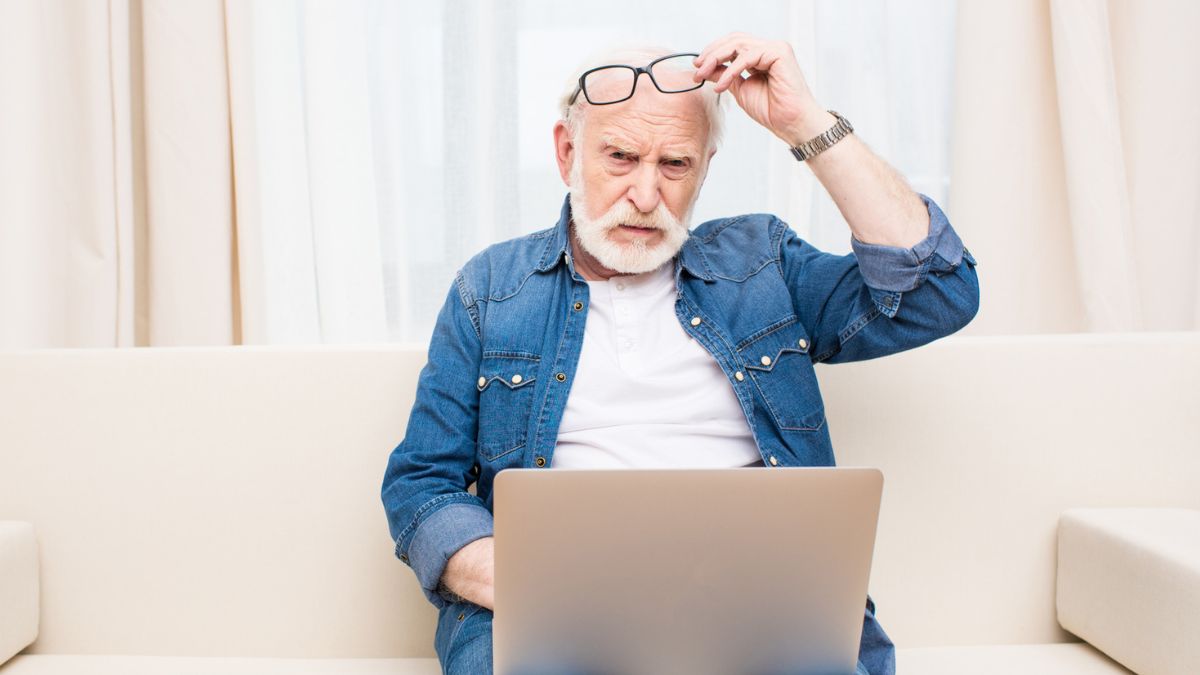 senior man with a laptop and glasses