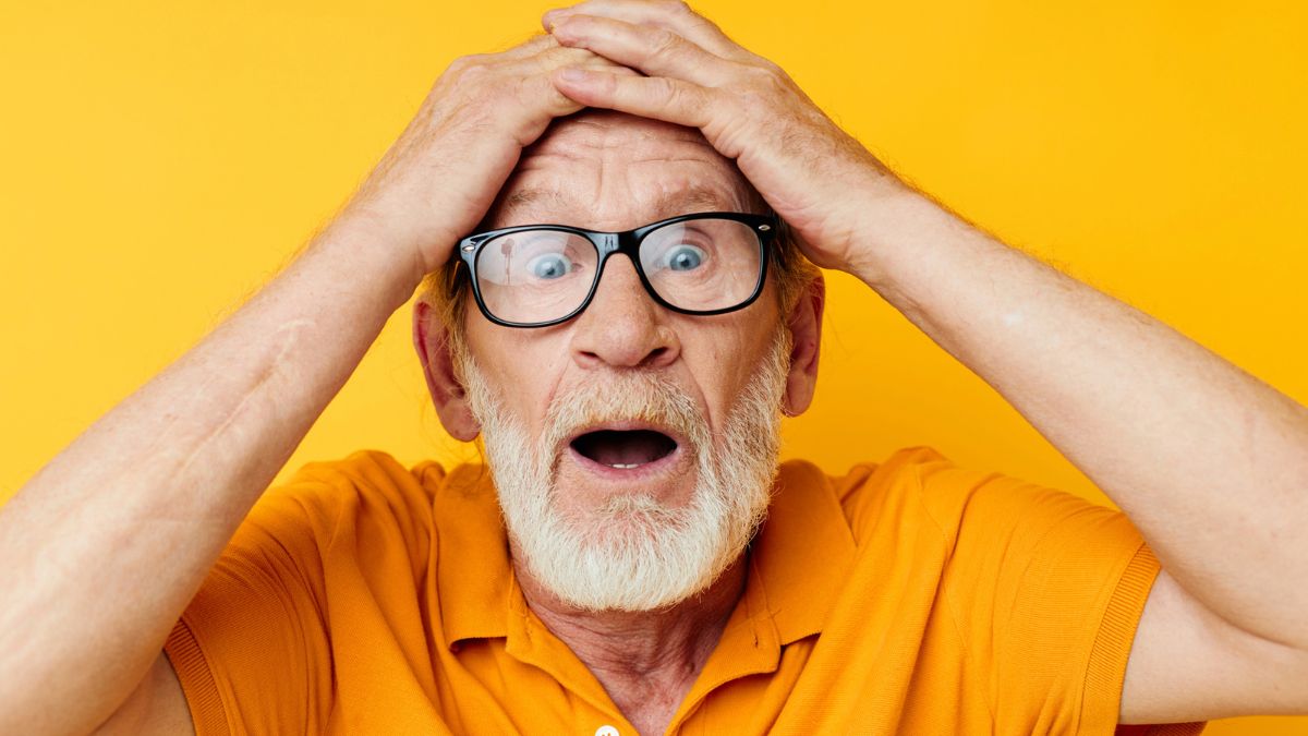 old man with glasses in shock surprised