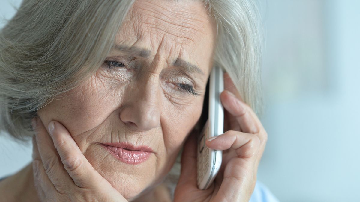 old woman sad on the phone