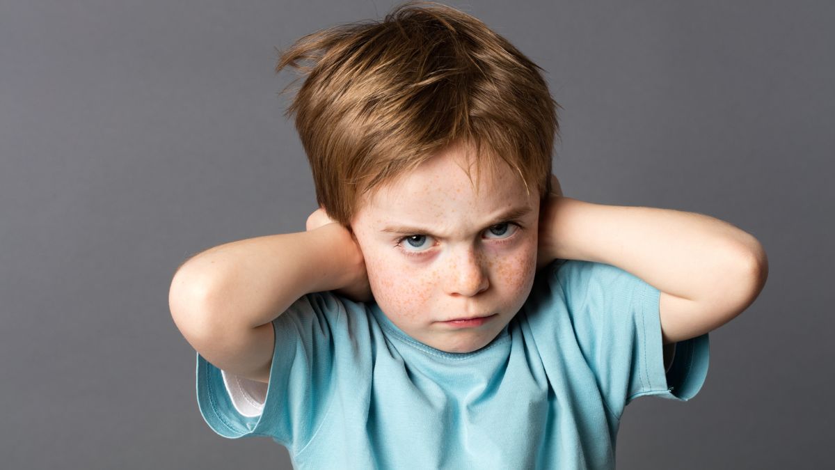 kid covering his ears