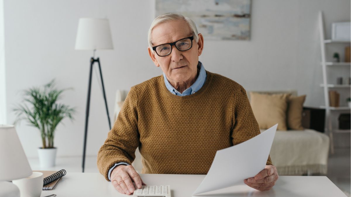 senior man with glasses and calculator