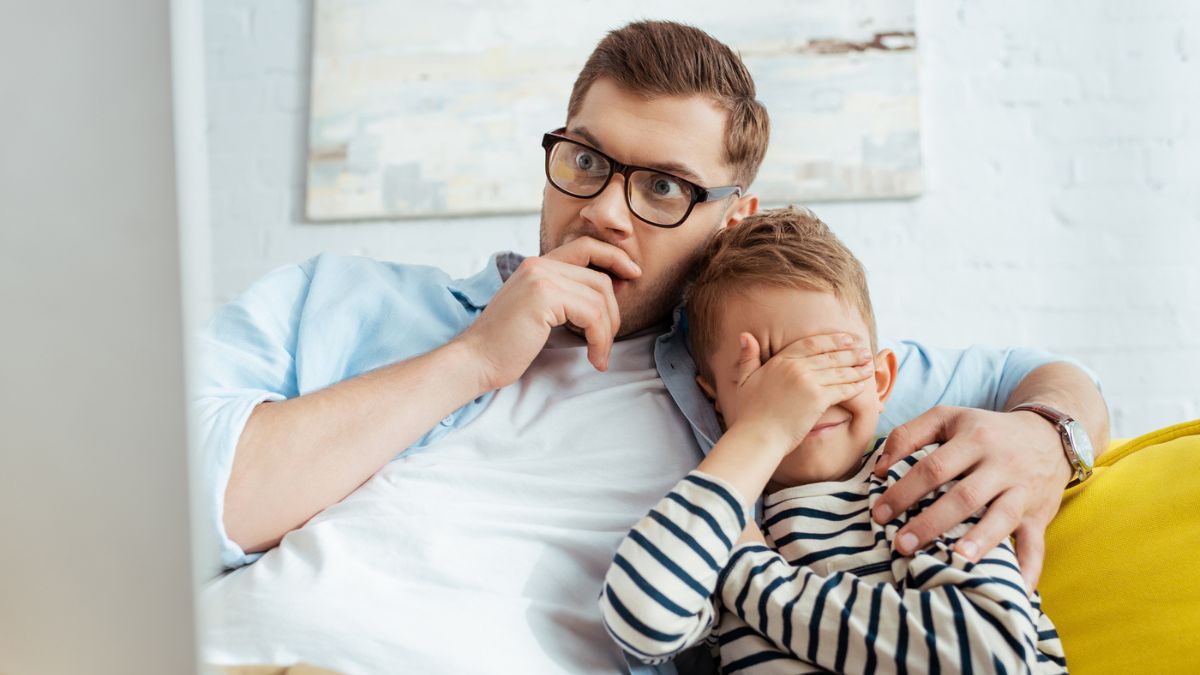 dad with glasses covering sons eyes