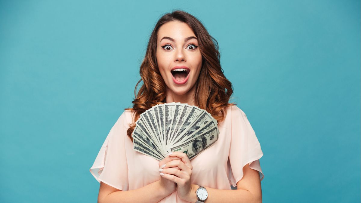 woman excited holding cash