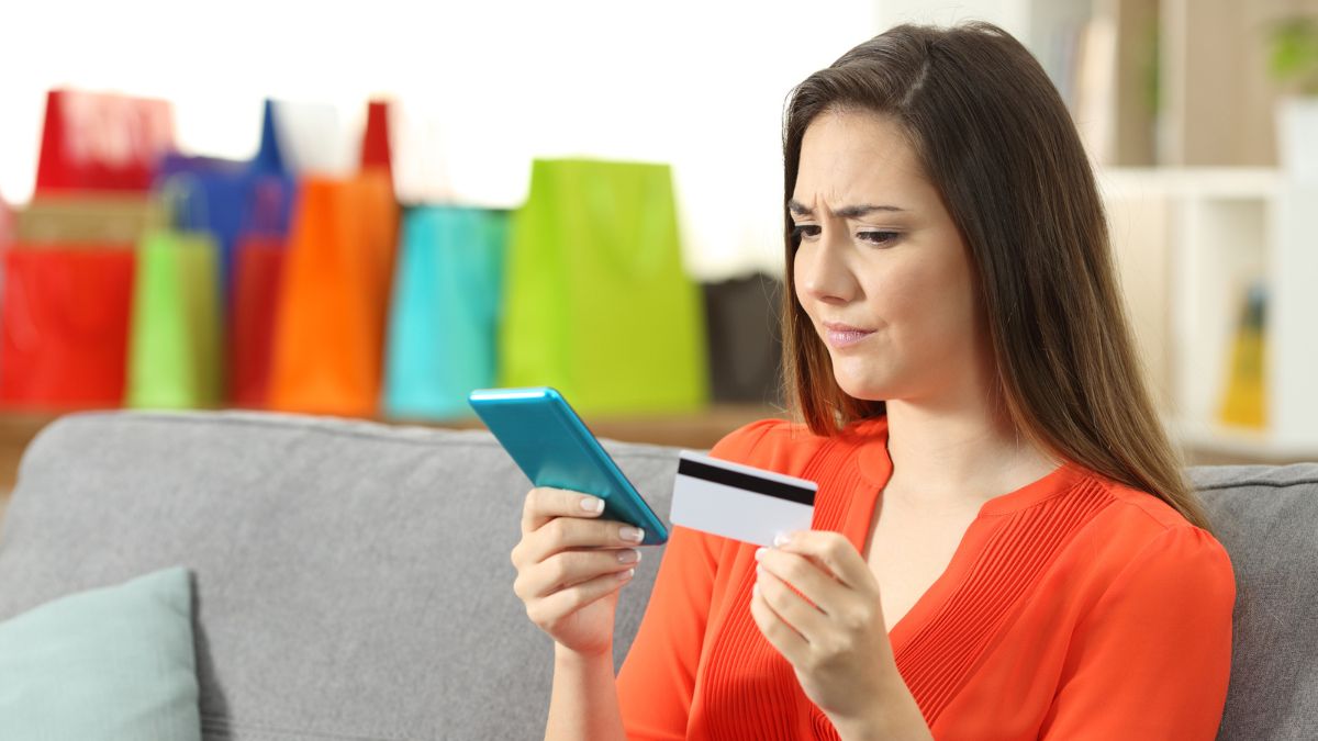 woman with a phone and credit card