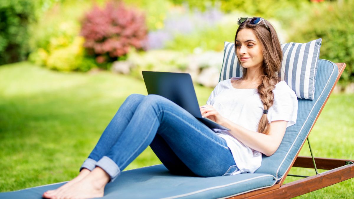 woman working on laptop in garden