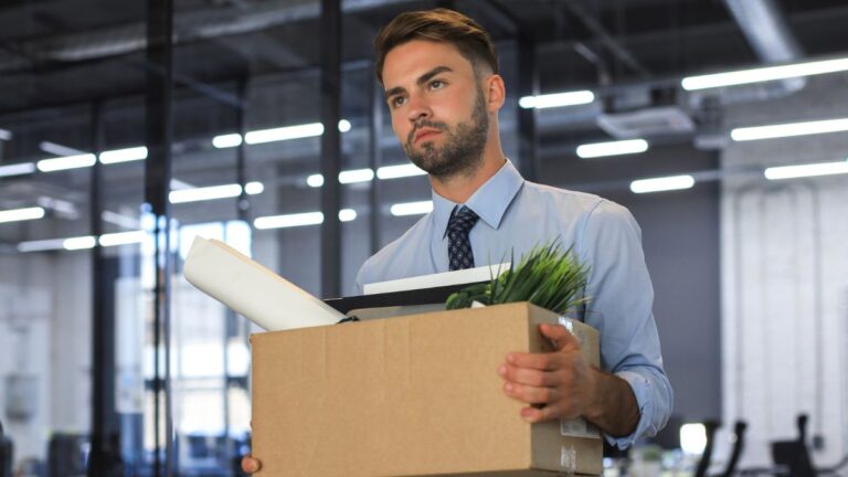 man carrying box fired