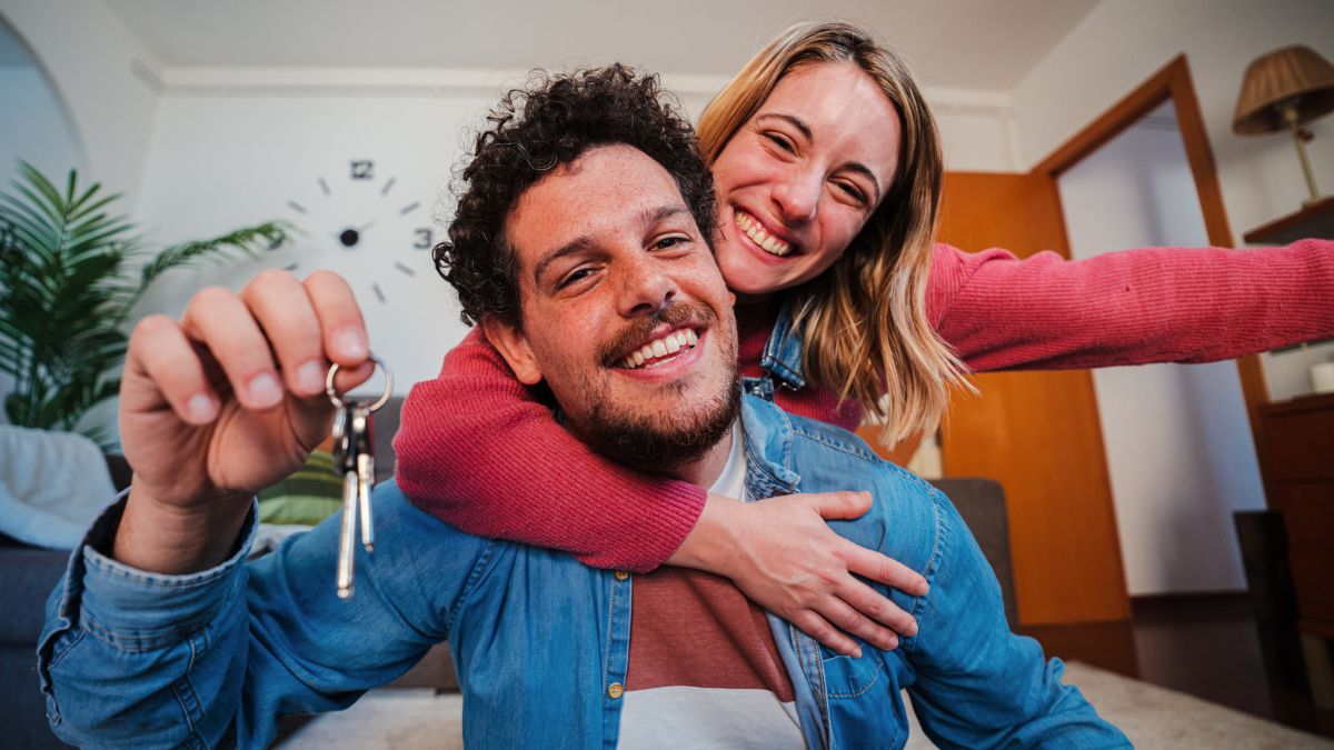 couple smiling with house keys