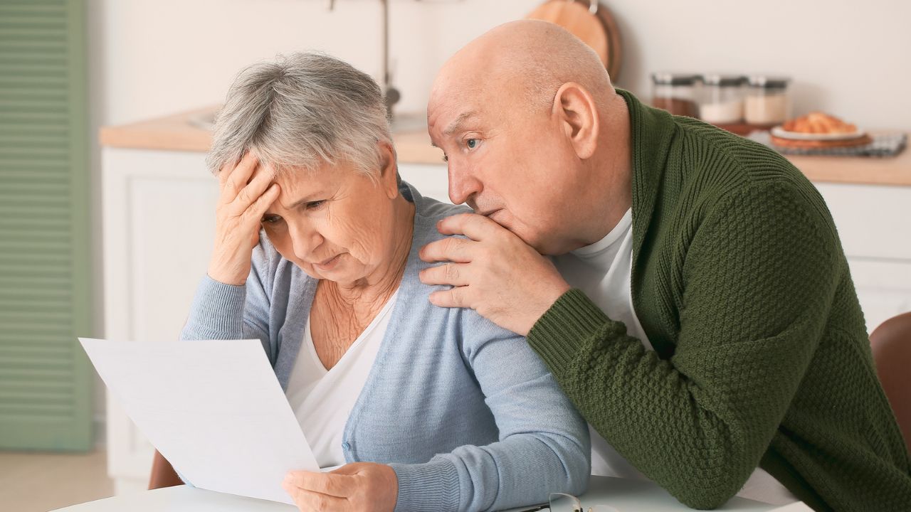 elder couple looking at documents
