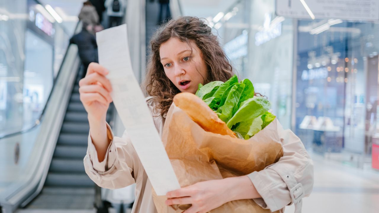 woman grocery looking at receipt
