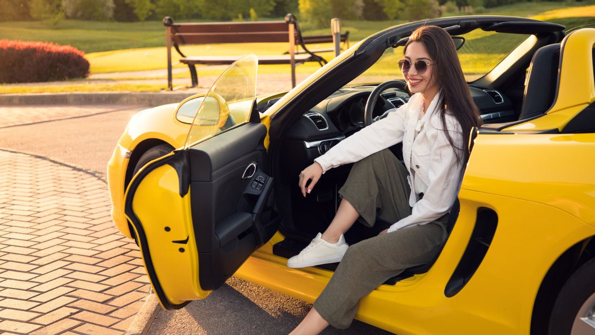 woman sitting in a sports car