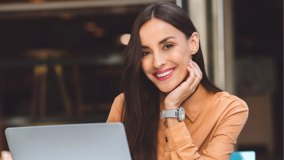 woman working a laptop smiling