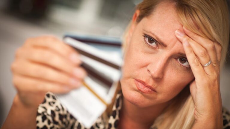 woman sad with credit cards