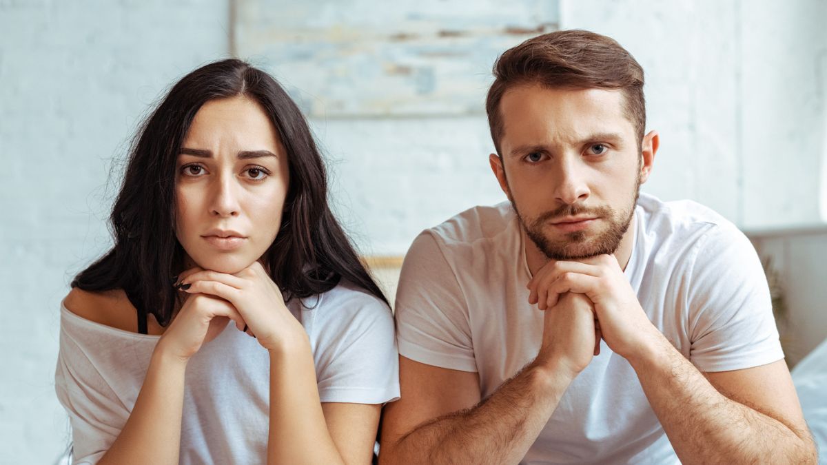 couple sad in their living room