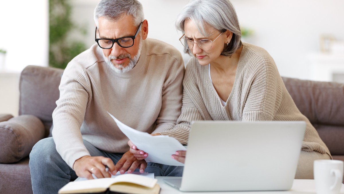 Worried senior family reading financial documents