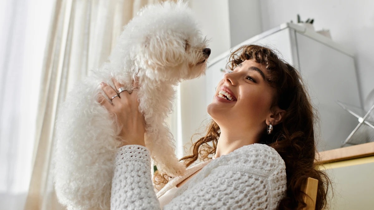 A young woman smiles with delight as she cuddles