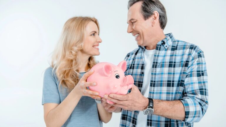 Couple holding piggy bank