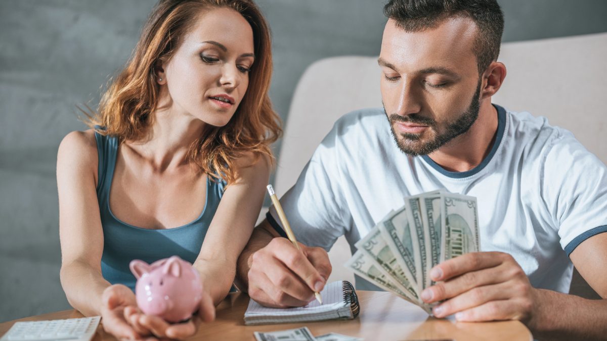 Couple planning family budget with piggy bank