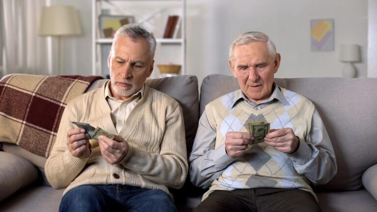 Depressed elderly men counting money, low social payment,