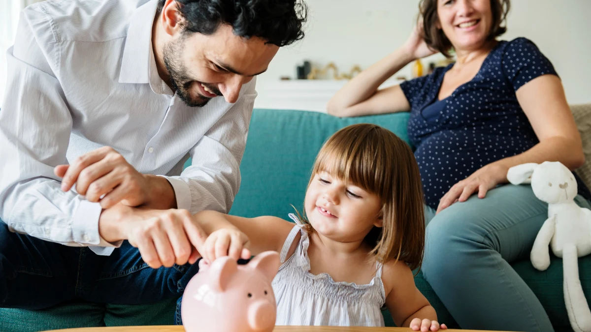 Family saving money in piggy bank